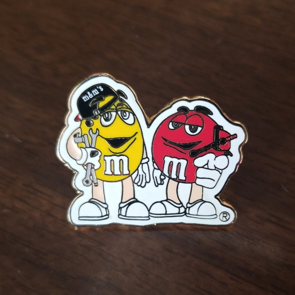 M&M mechanical Yellow and Red lapel pin